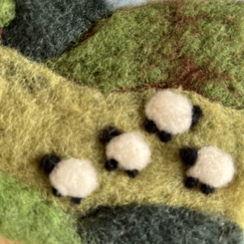 Handmade wool felt landscape picture with sheep