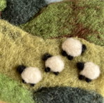 Handmade wool felt landscape picture with sheep