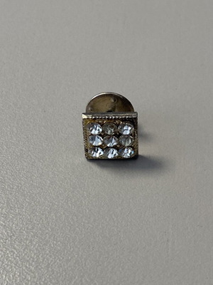 Unisex lapel pin with rhinestones used, silver color