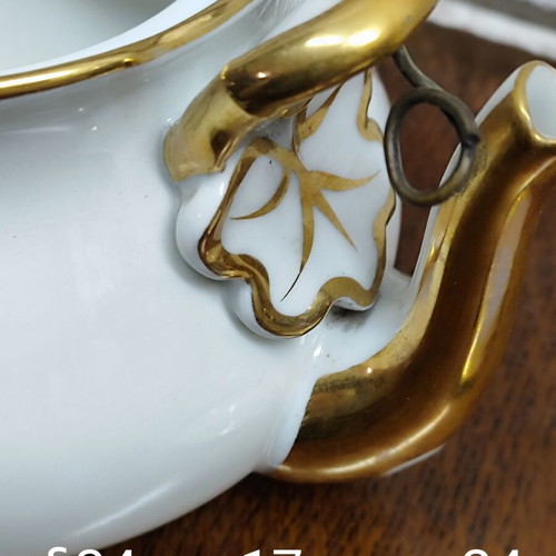 Antique porcelain teapot with wooden handle used