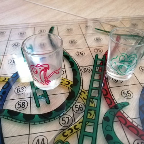 Glass Snakes & Ladders board game used with shot glasses