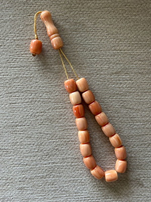 Komboloi used, coral-colored resin beads
