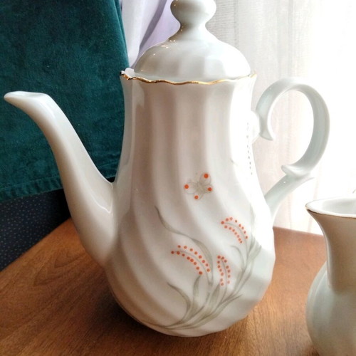 Porcelain teapot and creamer set like new with embossed designs