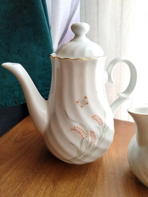 Porcelain teapot and creamer set like new with embossed designs