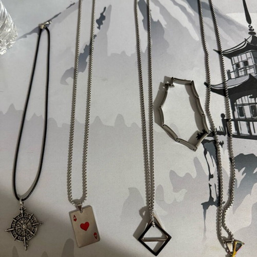 Necklaces and bracelet new with compass, playing card, shapes and gun