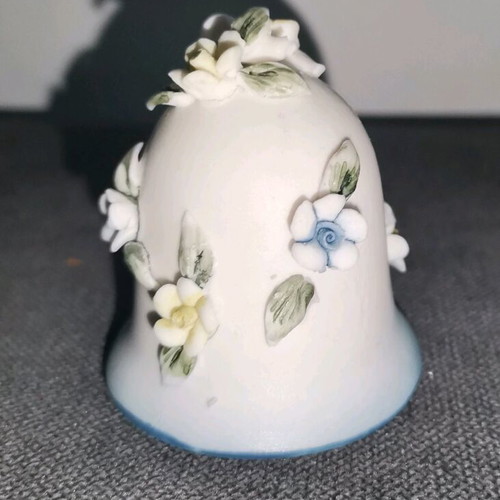 Ceramic bell used with embossed flower designs