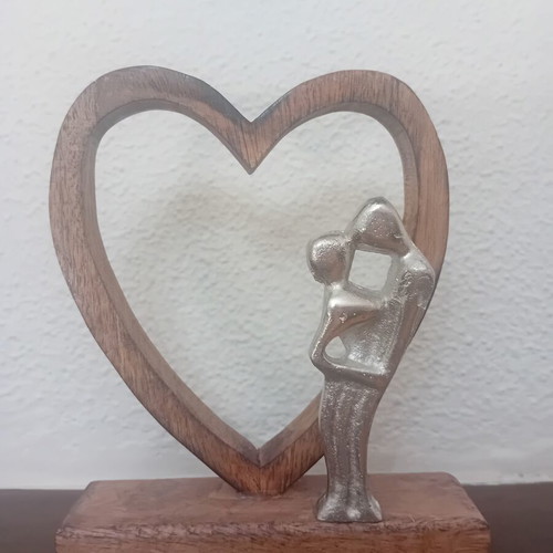 Decorative wooden heart sculpture with couple figure