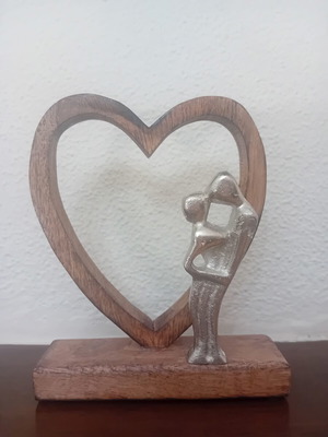 Decorative wooden heart sculpture with couple figure