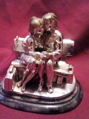 Decorative couple on bench used
