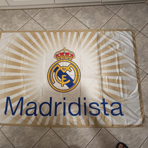 Real Madrid and Olympiakos accessories used with flag, scarf, and cap