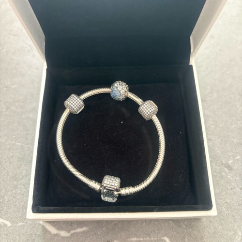 Pandora silver bracelet new with 4 charms and zirconia