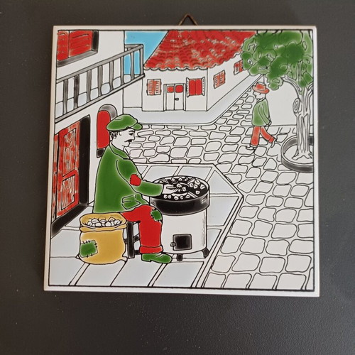 Ceramic tile decorative with traditional chestnut seller, like new