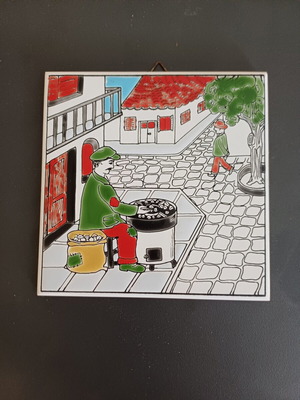 Ceramic tile decorative with traditional chestnut seller, like new