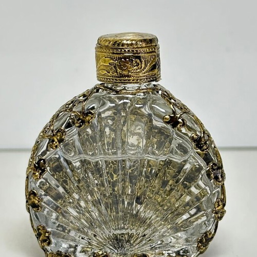 Vintage perfume flacon with filigree metalwork and red cabochon