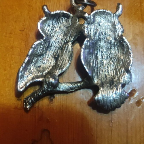 Silver pendant with two owls and dark blue stones