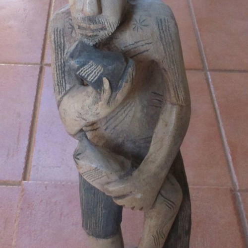 Wooden carved figure used from Colombia with traditional Pan flute
