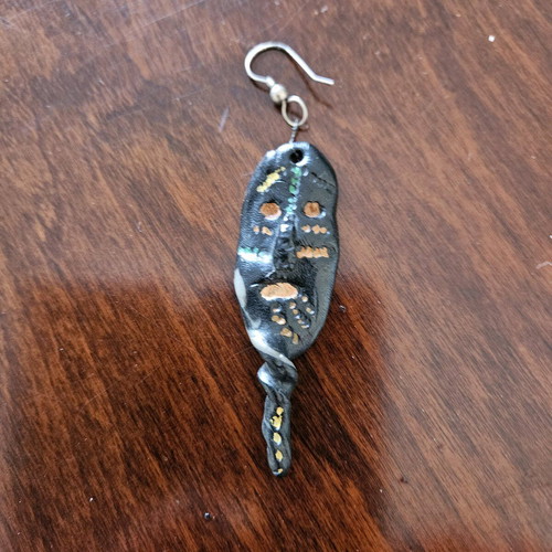 Black earring used, totem-inspired with multicolor pattern