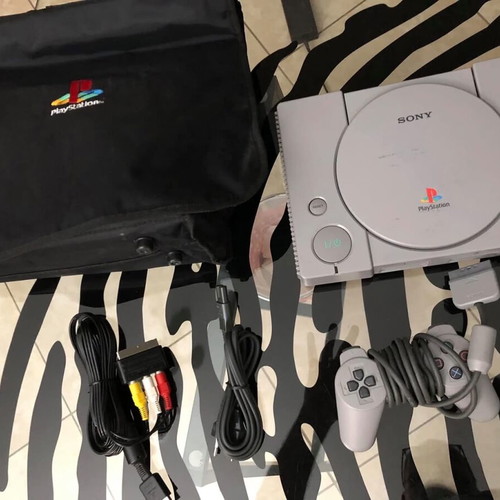 Sony PlayStation console used with official bag, controller and cables