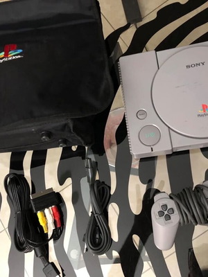 Sony PlayStation console used with official bag, controller and cables