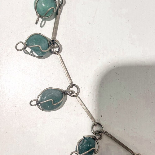 Silver necklace with green precious stones used