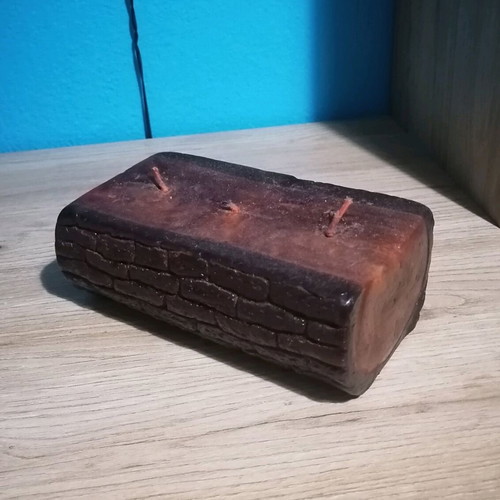 Handmade candle in wood log shape like new