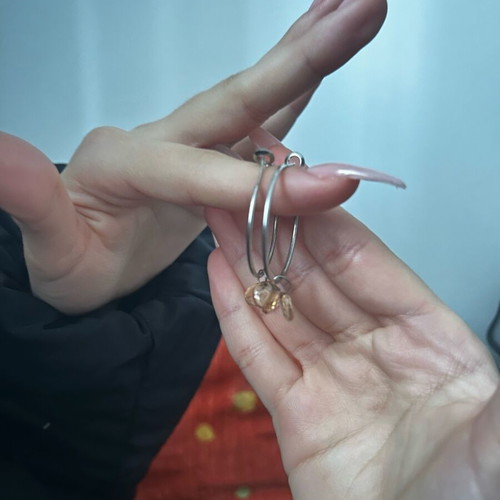 Silver earrings used with gray and orange details