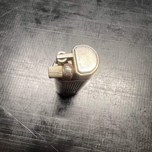 Silver lighter used, unknown if working