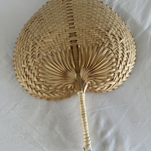 Handmade fans used, natural materials palm leaves and rattan