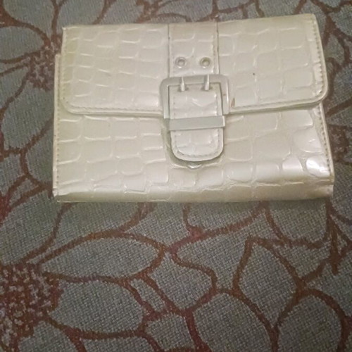 Beige wallet used with card slots and bill compartment