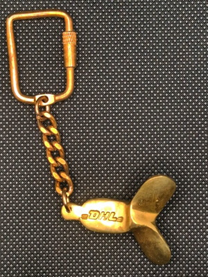 DHL keychain like new, rare collectible, gold-colored