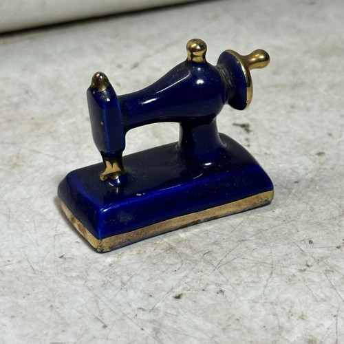 Vintage porcelain miniature sewing machine with gold details, used