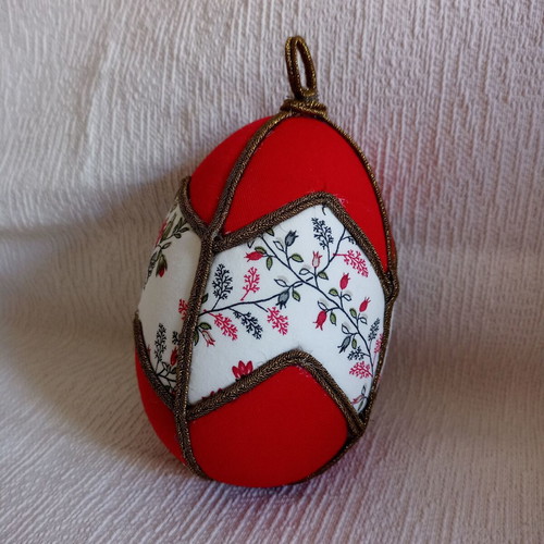 Decorative red egg used with geometric design and bronze border