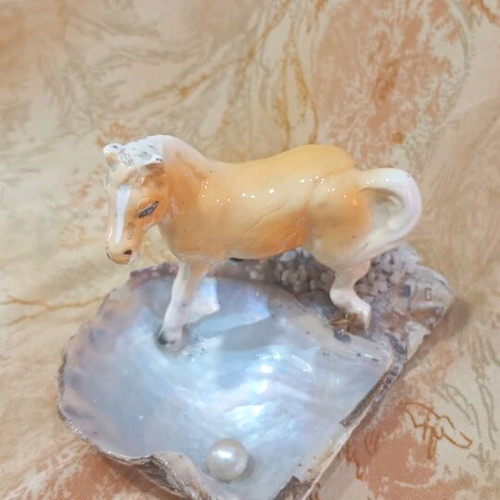 Decorative shell used with ceramic horse