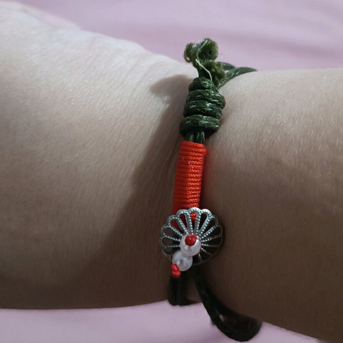 Bracelet new with various charms on green cord