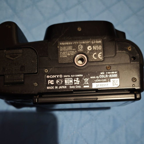 Sony A500 camera used with two lenses, battery, SD card, and carrying case
