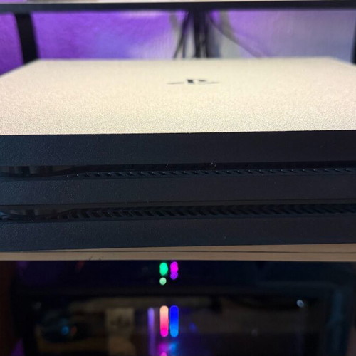 PlayStation 4 Pro used with controller and two games