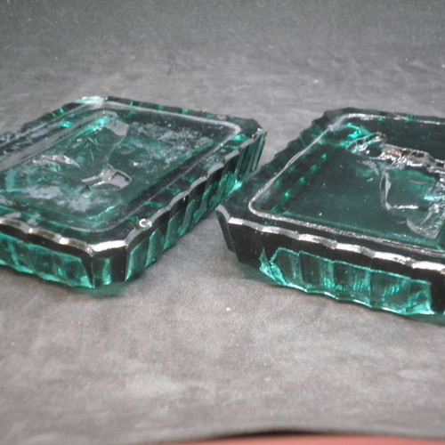 Antique ashtrays pair used with embossed dogs in dark green glass