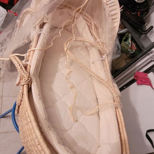 Baby bassinet used with wooden base and beige mattress