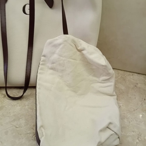 Large beige fabric shoulder bag with brown leather details