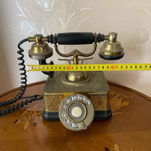 Vintage brass telephone used with embossed designs