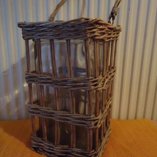 Decorative lantern used with thick glass and wicker
