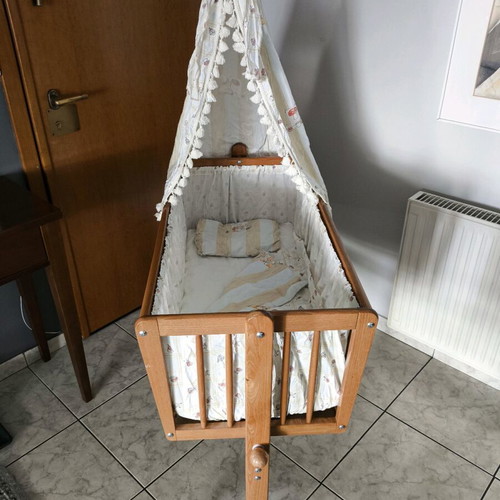 Wooden baby cot like new with wheels and mosquito net