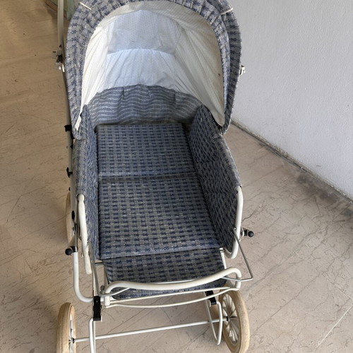 Vintage baby stroller with classic check fabric and metal frame