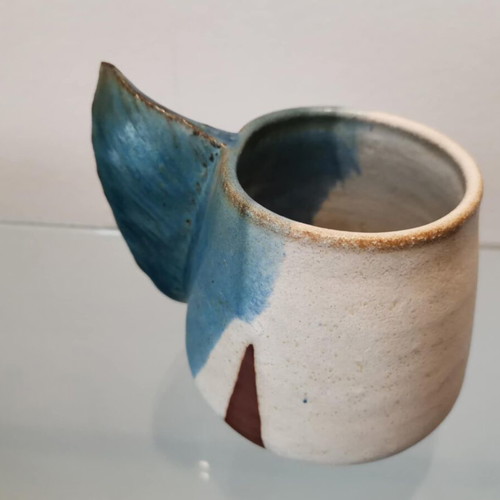 Clay handmade mug used with wavy handle