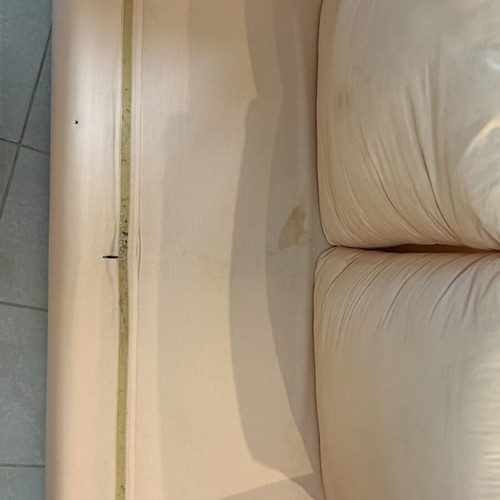 Fabric two-seater sofa used, light pink-peach with side cushions