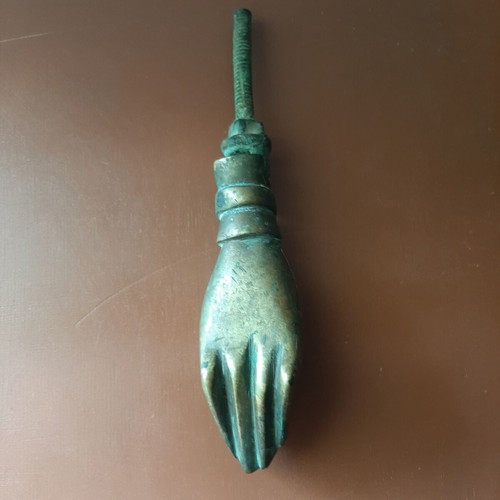 Antique bronze door knocker in hand shape