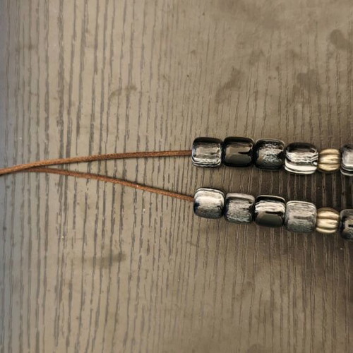 Worry beads used with black and white beads, metallic elements