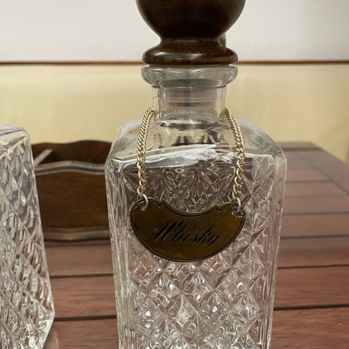 Vintage English decanters used in wooden stand for gin, cognac, whisky