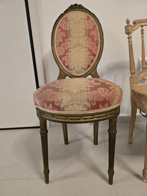 Carved antique chair with fabric upholstery