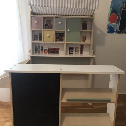 Wooden play shop with accessories and blackboard